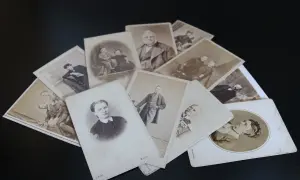 Un tas de vieilles photographies, peut-être de la commune de naissance, montrant des hommes, des femmes et des enfants en tenues d'époque.